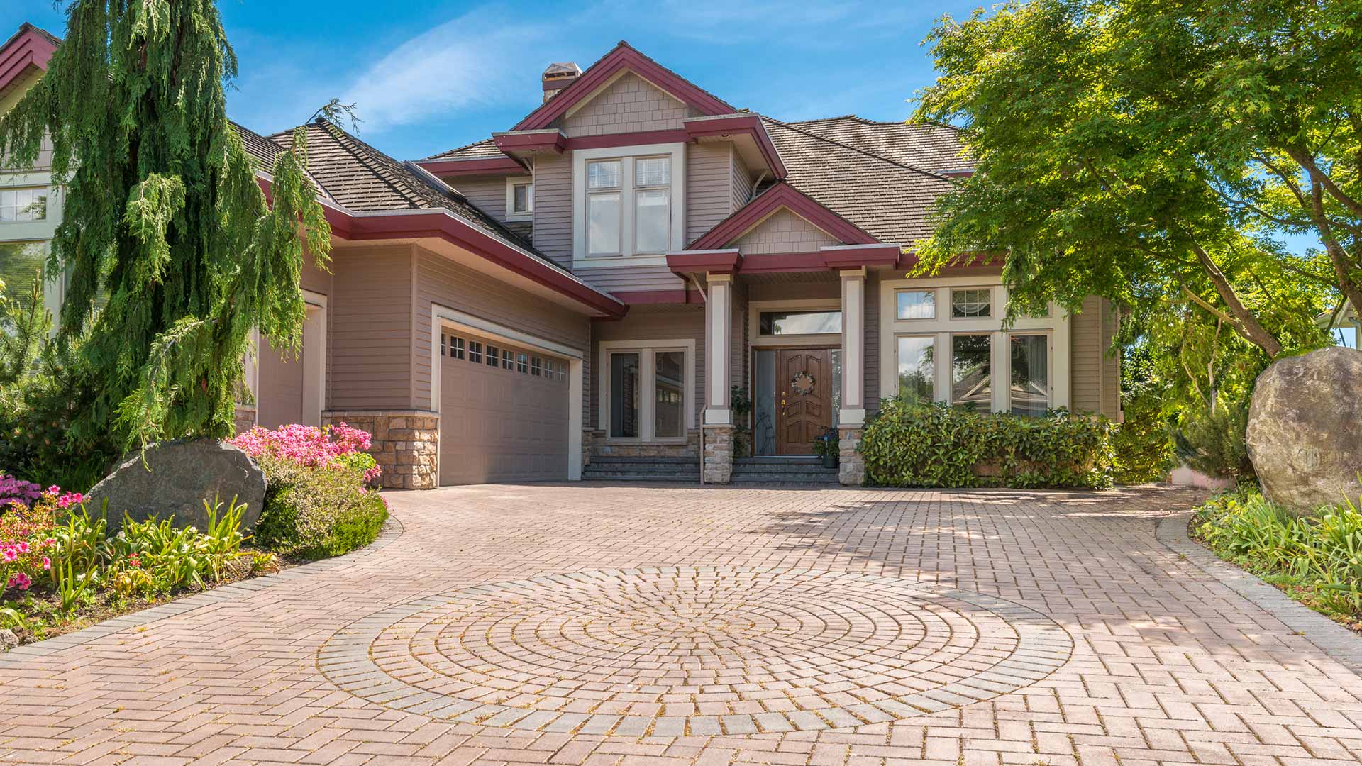 A beautiful home front with a custom driveway