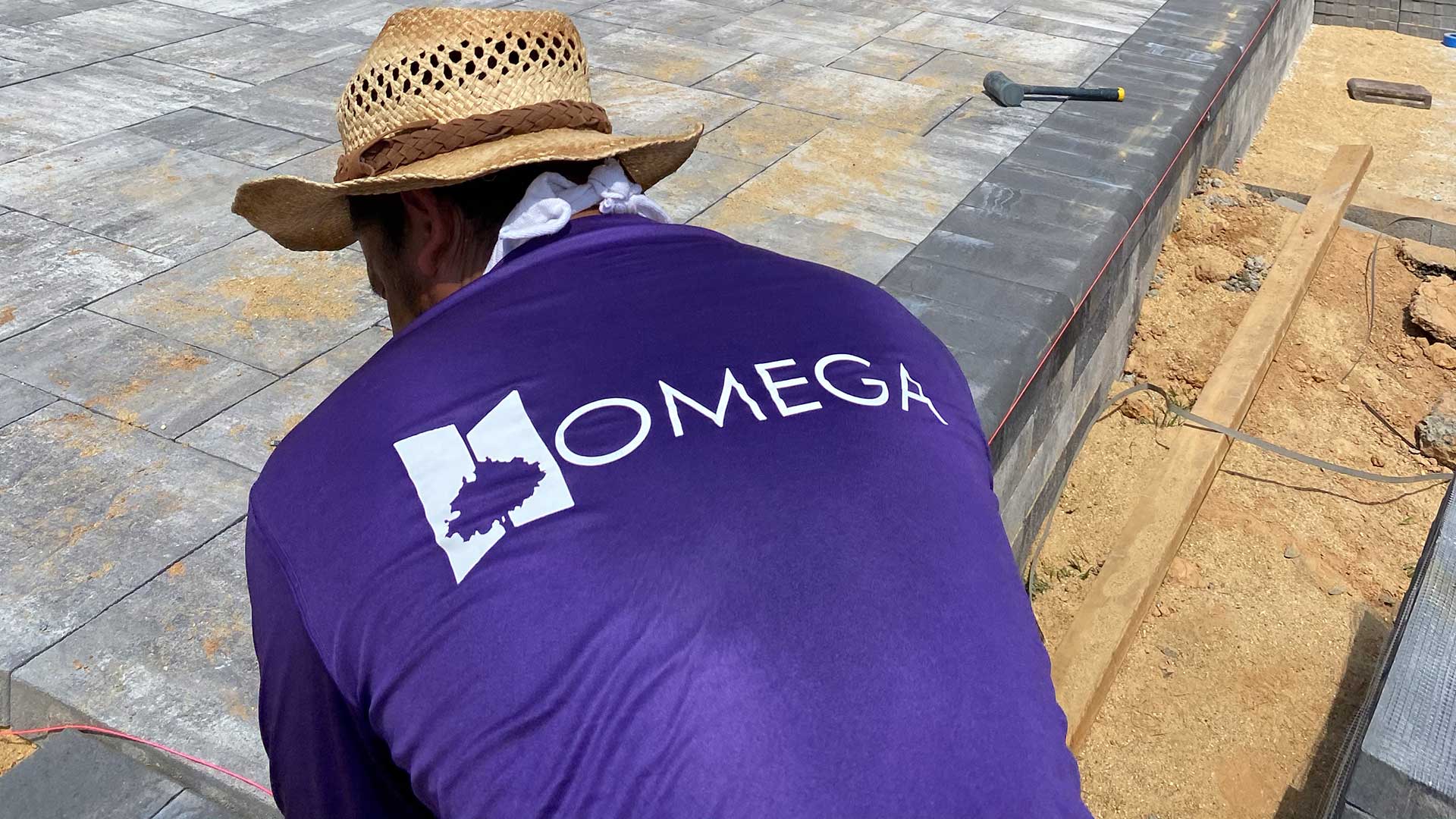 Omega Landscape Construction worker building a custom patio in Middleburg, VA.