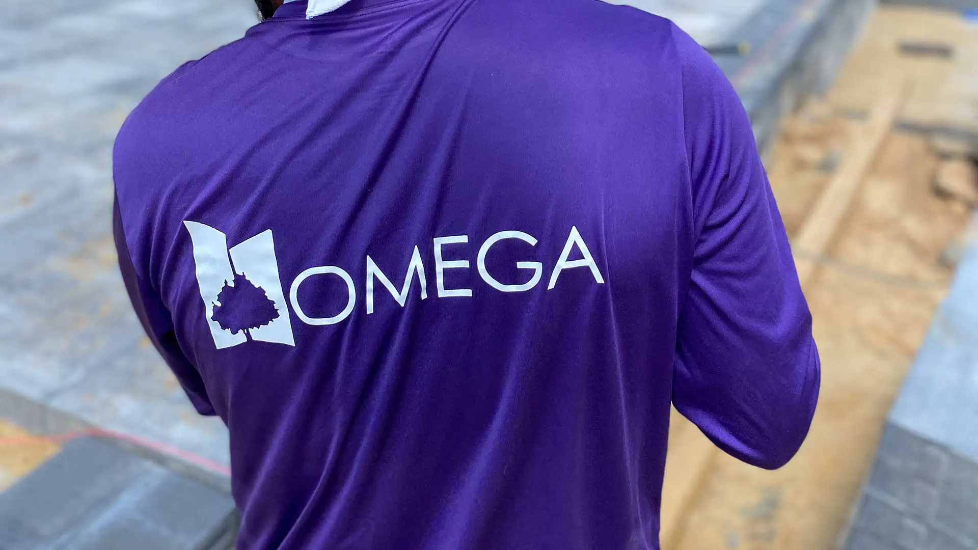 Omega Landscape Construction construction worker with a purple company shirt near Purcellville, VA.
