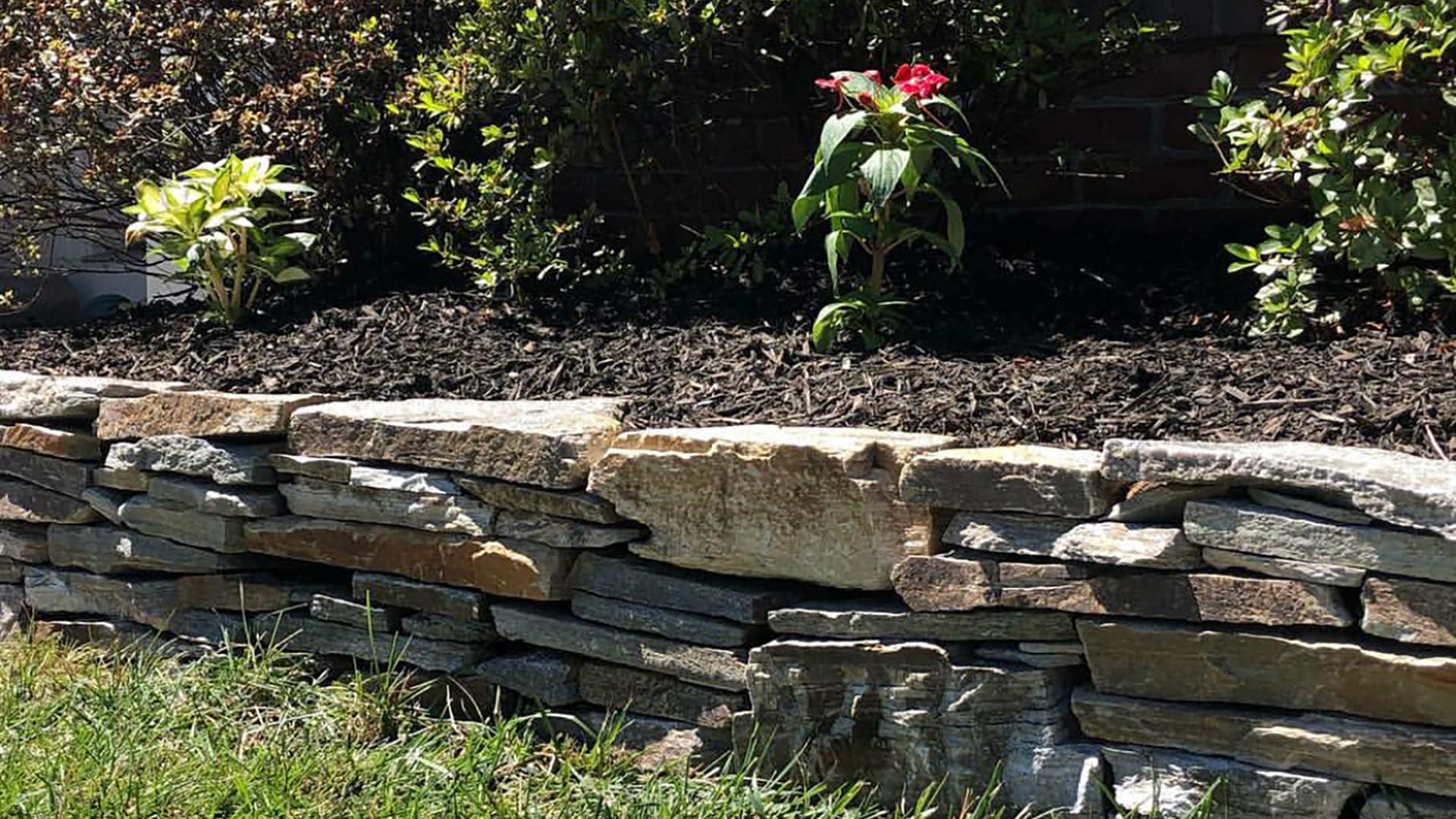 A retaining wall around a landscape bed for a customer in Haymarket, VA.
