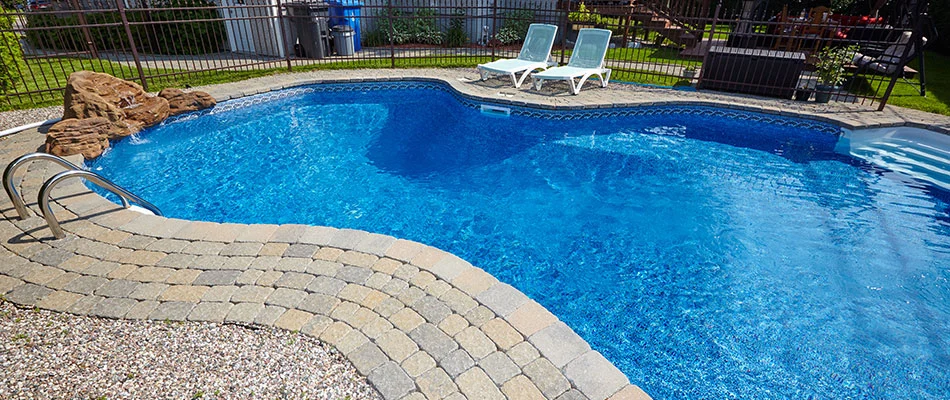 Pool with stone paved deck in Purcellville, VA.