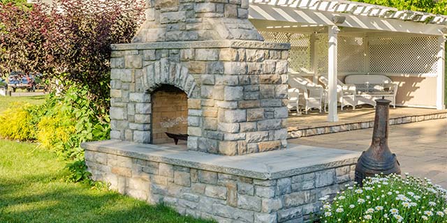 Custom stone outdoor fireplace installed at a home in Purcellville, VA.